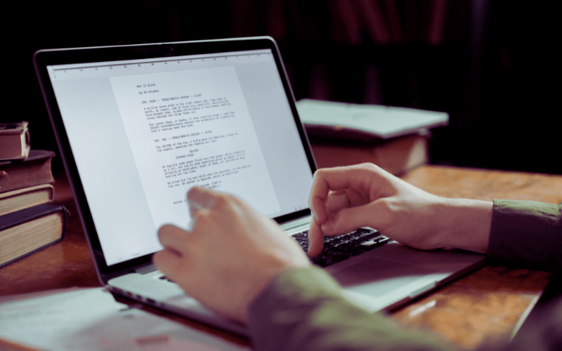 hands typing on a laptop keyboard